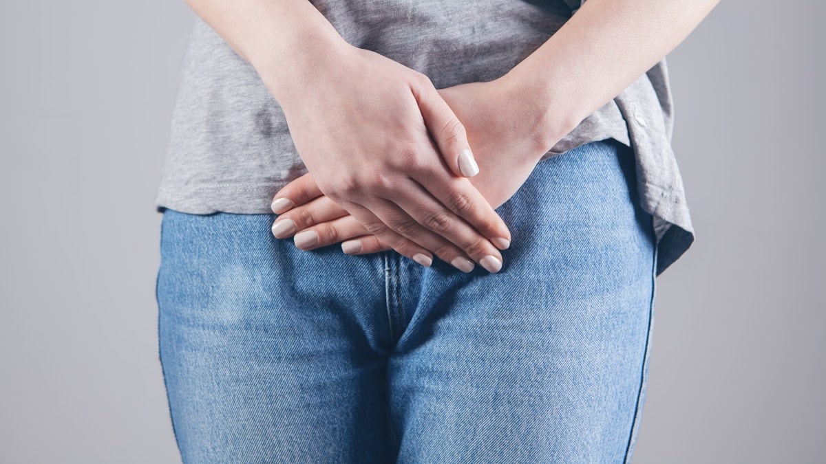 man in gray shirt and blue denim jeans